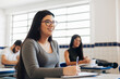 © kleberpicui - Young Brazilian university student sitting at her desk during class.