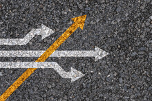 Different Thinking And Business And Technology Disruption Concept , Yellow Arrow Cross Direction With White Arrow On Road Asphalt.