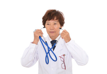 Senior Chinese female doctor removes the stethoscope clipped on the ear