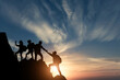 © phonix_a - Silhouette male hiker groups celebrating success on top of a mountain in a majestic sunset and Two climber helping to hike up . Concept for success ,help, teamwork and Leadership concept .