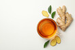 Fresh ginger and cup of tea on white background