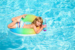 © Volodymyr - Cocktail on watter pool in the summer. Children with in swim ring the swimming pool.