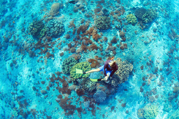 Happy family vacation. Man in snorkeling mask with camera dive underwater with tropical fishes in coral reef sea pool. Travel lifestyle, water sport outdoor adventure, swimming on summer beach holiday