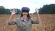 © emaria - Beautiful girl in a golden wheat field uses virtual reality glasses