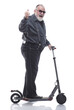 © ASDF - elderly man with an electric scooter shows the OK gesture