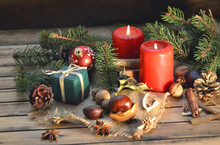 Traditional Christmas Decoration On Wooden Table With Candles And Gift Box