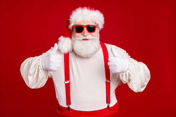 Wall Mural - Close-up portrait of his he nice handsome cheerful cheery glad bearded Santa showing two double thumbup advice cool advert ad isolated bright vivid shine vibrant red color background