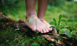 Leinwandbild Motiv Bare feet of man standing barefoot outdoors in nature, grounding concept.