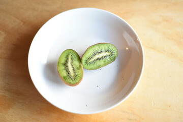 Fresh Whole and Cutted Kiwi in the Plate