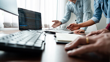 Team of Programmer working to find solution to problem and coding technologies in a software developing company office.