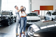 © fotofabrika - Young happy couple just bought a new car in a dealership
