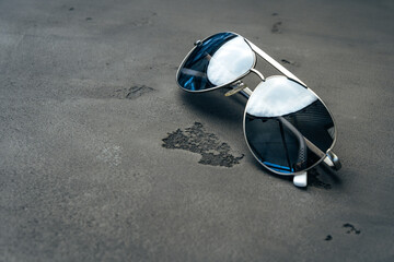 Sticker - New dark aviator glasses on grey concrete background