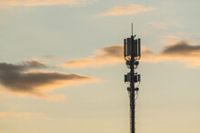Cellular / 5G Antenna At Sunset With A Bird Sitting On It
