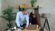 © viacheslav - Smiling woman and man employees working together in an office preparing presentation for meeting. Manager shows report to businessman on laptop computer
