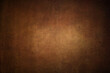 Grunge brown distressed background, old paper textured layout of light center and dark vignette edges 
