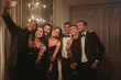 © Jacob Lund - Man taking selfie with his friends at celebration party
