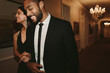 © Jacob Lund - Smiling young couple walking in corridor of nightclub