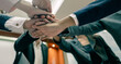 © Garun Studios - Business group with hands together - teamwork concepts