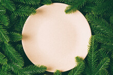 Top View Of Round Festive Plate On Fir Tree Background. Christmas Dish Concept With Empty Space For Your Design