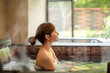 © Tom Wang - Asian Young woman relaxing in hot spring