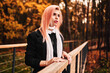 © MineevPh - Girl with pink hair walks in an autumn park