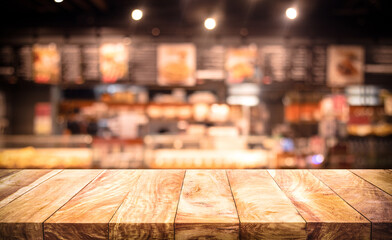 Wall Mural - Wood table top (Bar) with blur light bokeh in dark night cafe,restaurant background.