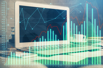 Double exposure of chart and financial info and work space with computer background. Concept of international online trading.