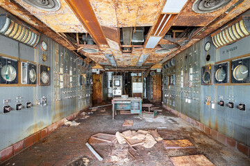  Inside a control room in an abandoned shut down power plant—vandalism, decay, destruction, debris