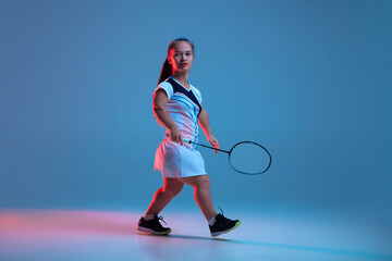 Wall Mural - Winner. Beautiful dwarf woman practicing in badminton isolated on blue background in neon light. Lifestyle of inclusive people, diversity and equility. Sport, activity and movement. Copyspace.