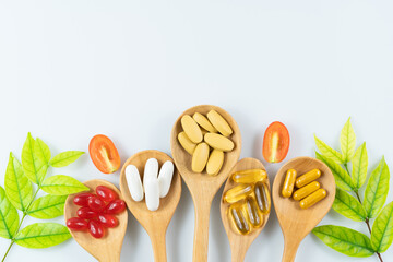 Wall Mural - Alternative medicine, pills tablet, capsule and vitamin organic supplements good for health in wood spoon on white background with copy space, medicine and drug concept