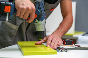 furniture assembly service concept. worker assembles furniture in the kitchen