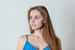 © Todayphoto - Caucasian women wearing a blue dress with. She is looking over her right shoulder
