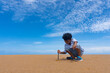 © pkproject - Asian boy play sand on the beach.