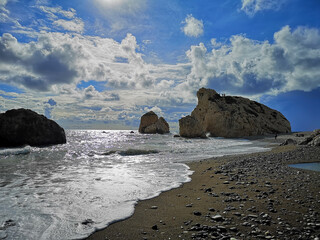 Sunny day on Petra tou Roumiou Beach. There is a legend that on this rock the Goddess Aphrodite was born.