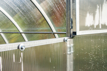 Wall Mural - Metal fasteners and ceilings in a polycarbonate greenhouse