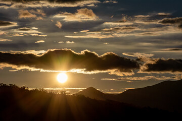 Wall Mural - Beautiful pictures and colorful sunset landscape with sun, mountains and trees, to use as wallpaper