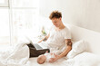 © Drobot Dean - Happy young father playing with his little baby son