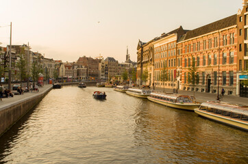 Amsterdam canal with boats and a beautiful sky