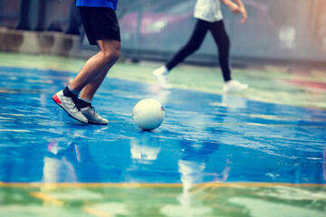 Sticker - Selective focus to soccer ball with futsal player run to shoot it. Youth futsal league.