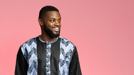 Wall Mural - Handsome black guy in african shirt looking at copy space