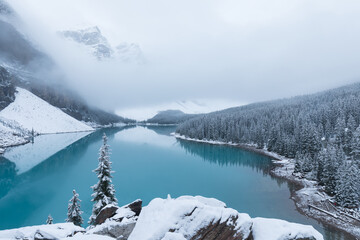 Wall Mural - first snow, morning at moraine lake in banff national park alberta canada snow-covered winter mounta