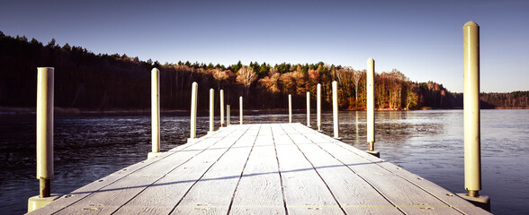 Wall Mural - Old Walking Wooden Bridge on a Frozen Lake