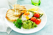 © ld1976 - Fried eggs in avocado with guacamole sauce. Breakfast. Selective focus