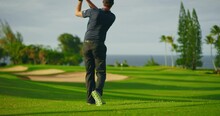 Man Playing Golf On Beautiful Luxury Resort Golf Course, Swinging And Hitting Golf Ball In Slow Motion