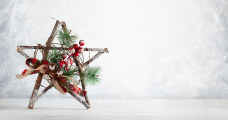 Poster - Christmas still life with decorated wooden Christmas Star on light background. Winter festive concept.