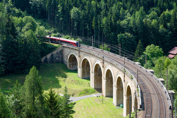  Train on the viaduct over the Adlitzgraben on the Semmering Railway. The Semmering Railway is the oldest mountain railway of Europe and a Unesco World Heritage site.