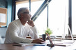 © opolja - Casual Grey-haired Mature Man Working At Desk In Busy Creative Office