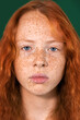 Portrait of a red-haired girl with freckles