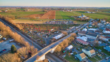 Aerial View Of An Amish Mud Sale With Lots Of Buggies And Farm Equipment On A Early Morning Winter Day