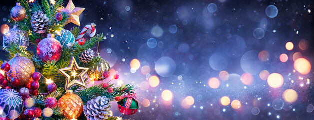 Wall Mural - christmas tree - ornaments hanging at pine tree with defocused lights in the shiny night